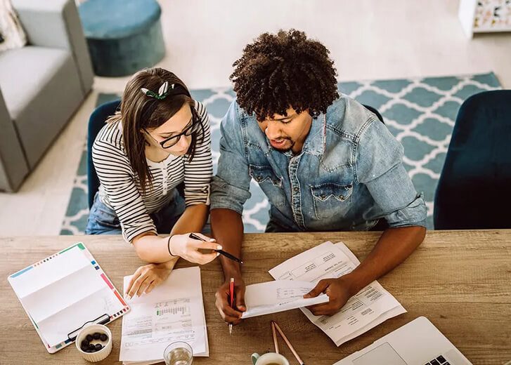 man and woman going through bills