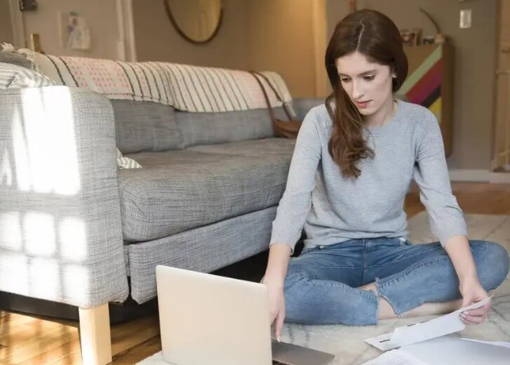 woman sitting on floor with laptop
