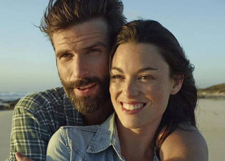 man and woman smiling