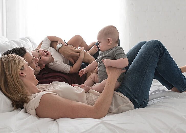 parents with kids in bed