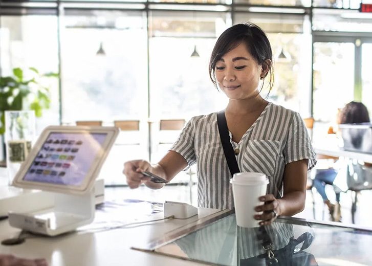 woman paying for coffee