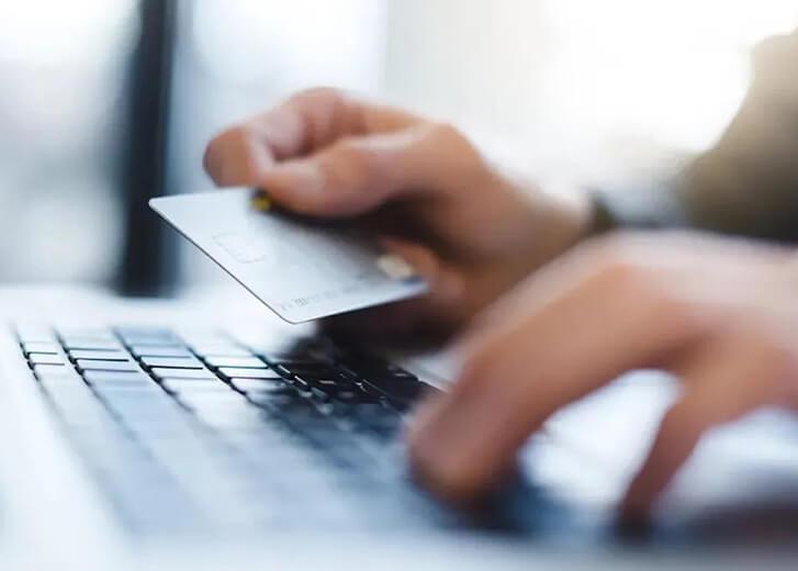 hand on credit card and keyboard